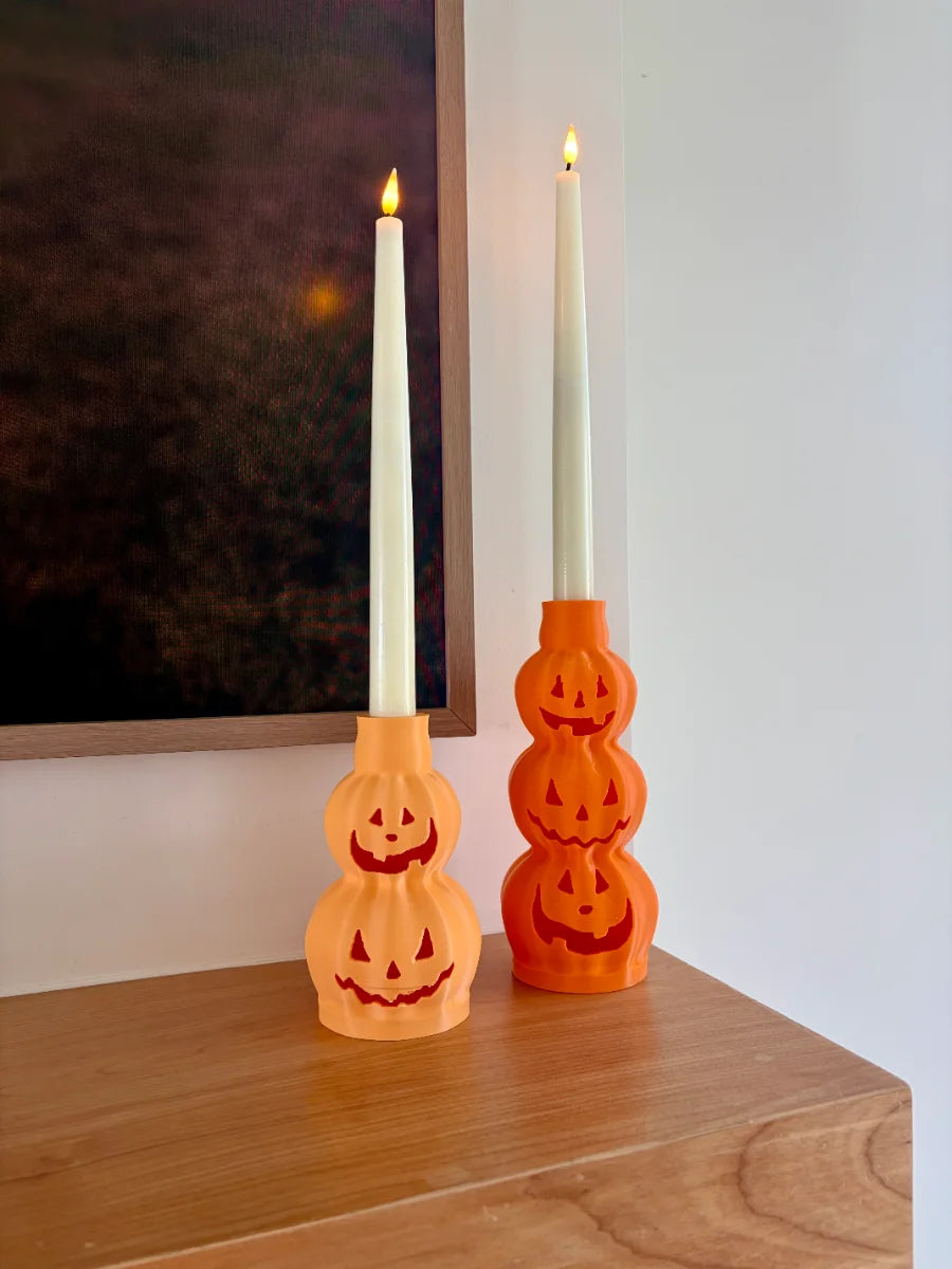 Stacked jack-o'-lantern 3D printed taper candle holder with carved faces