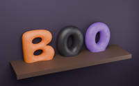 Close-up of 3D printed Halloween bubble letters spelling BOO in orange, black and purple, showing the raised Halloween icons